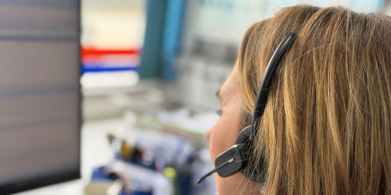 operadora al teléfono, simbolizando atención personalizada en el servicio de paquetería urgente
